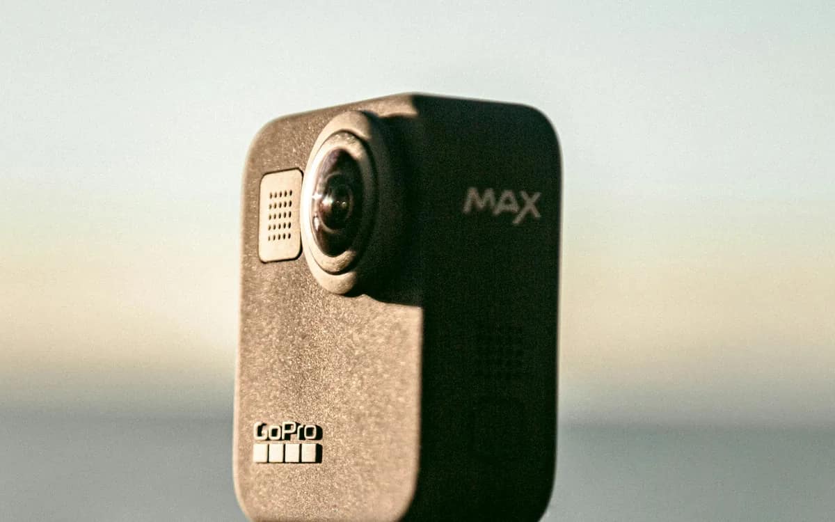 Due fotocamere Insta360 X5 viste frontalmente, lenti sferiche sporgenti, sotto spruzzi d'acqua